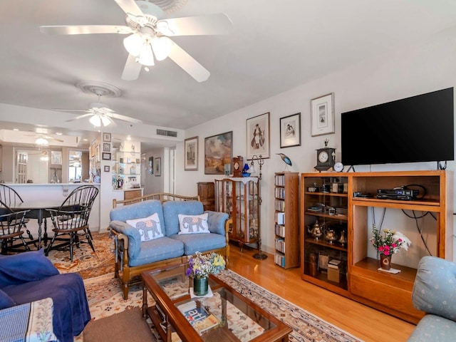 living room featuring visible vents and wood finished floors