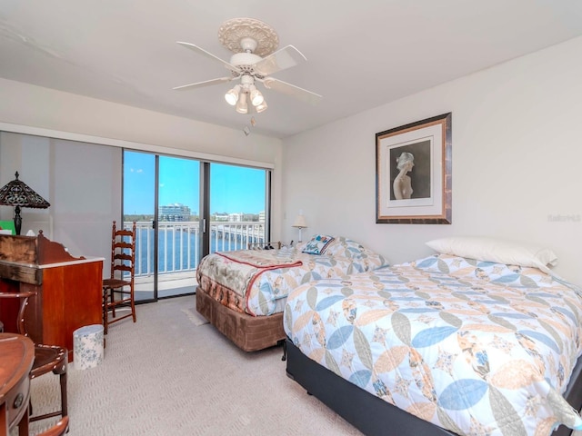 carpeted bedroom featuring access to outside and ceiling fan