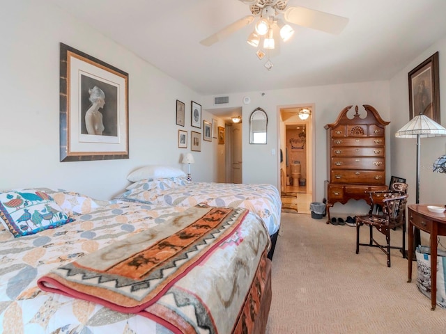 bedroom with visible vents, light carpet, and ceiling fan