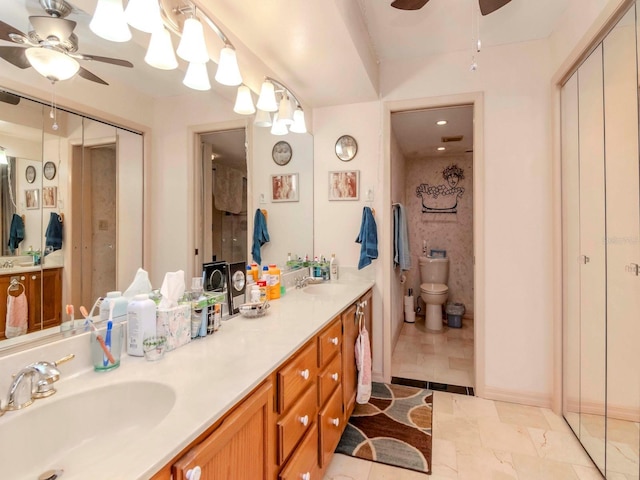 bathroom with a sink, double vanity, and a ceiling fan