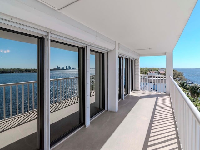 balcony with a sunroom and a water view