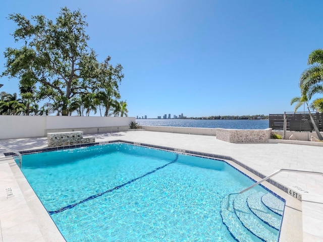 community pool featuring a patio and fence