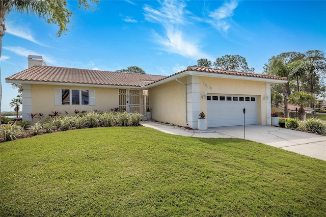 view of front of property featuring driveway, a front lawn, a garage, a chimney, and a tiled roof