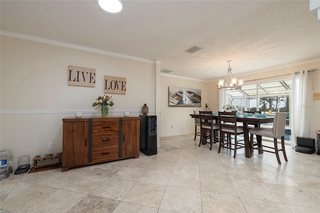 dining space with a chandelier, visible vents, a textured ceiling, and ornamental molding