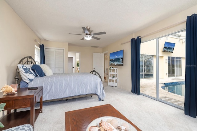 bedroom featuring visible vents, access to exterior, a textured ceiling, carpet floors, and ceiling fan