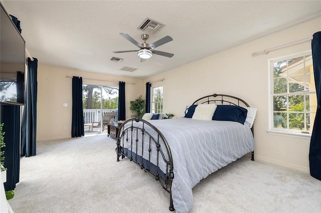 bedroom with visible vents, light colored carpet, and access to exterior