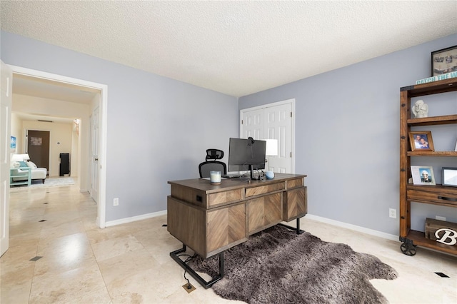 office with baseboards and a textured ceiling