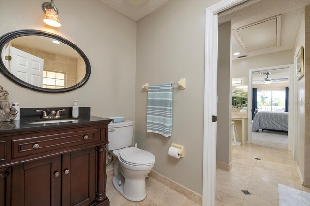 ensuite bathroom with tile patterned floors, toilet, ensuite bath, baseboards, and vanity