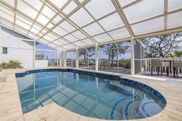 pool featuring glass enclosure, a patio, and outdoor dining area