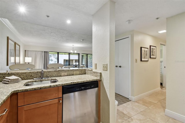 kitchen featuring dishwasher, light stone counters, brown cabinetry, and a sink