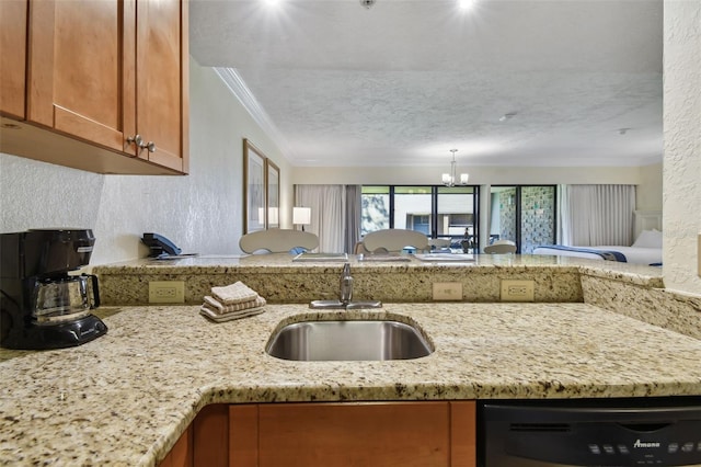 kitchen with a textured wall, dishwashing machine, a sink, light stone countertops, and brown cabinetry