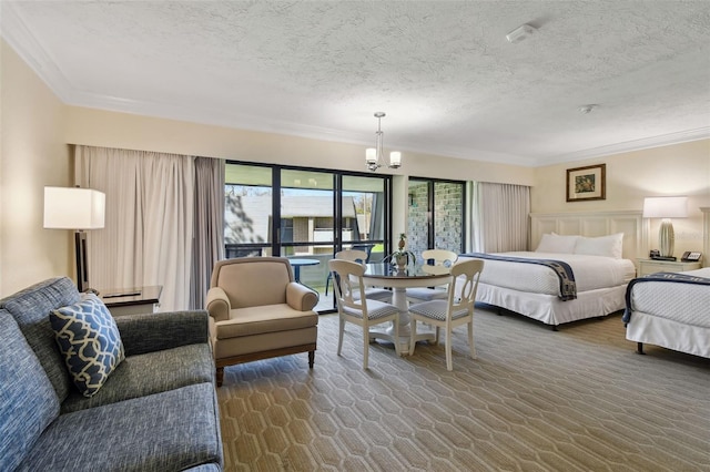 carpeted bedroom featuring a notable chandelier, a textured ceiling, and crown molding