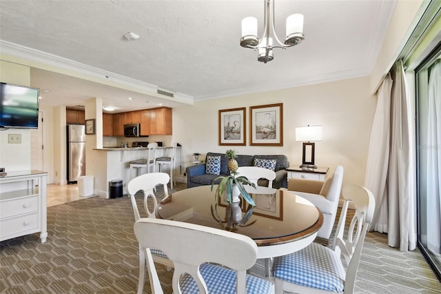 dining room featuring light carpet, ornamental molding, a chandelier, and a textured ceiling