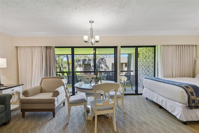 carpeted bedroom with a textured ceiling, ornamental molding, and a notable chandelier