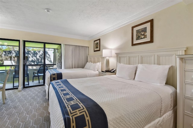 bedroom featuring ornamental molding, carpet flooring, and a textured ceiling