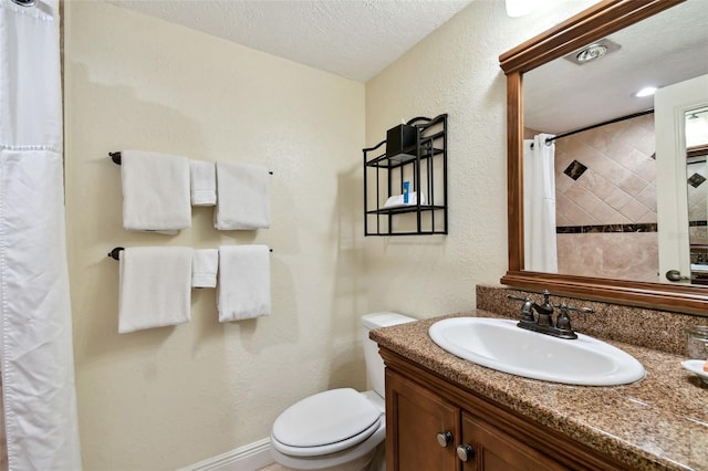 bathroom featuring a textured ceiling, a textured wall, curtained shower, toilet, and vanity