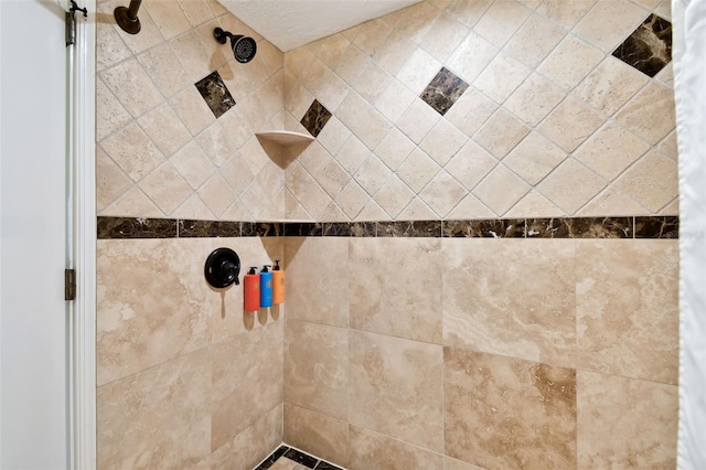 interior details featuring a tile shower