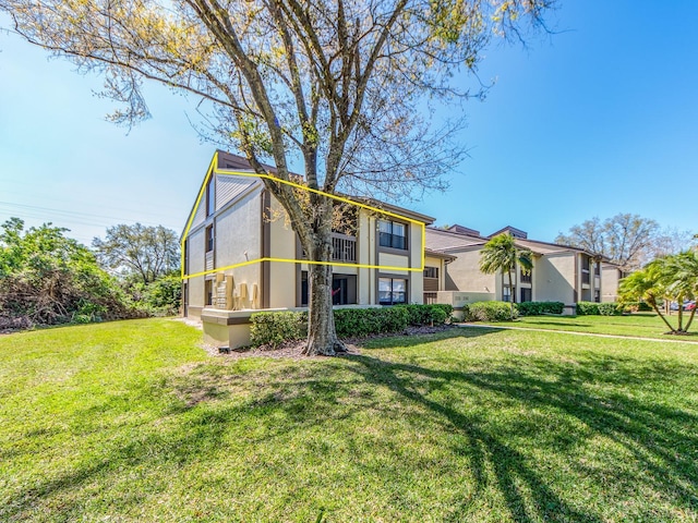 view of front of house with a front lawn and stucco siding