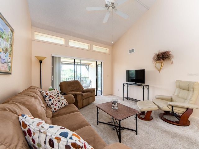 living area featuring light carpet, visible vents, high vaulted ceiling, and a ceiling fan