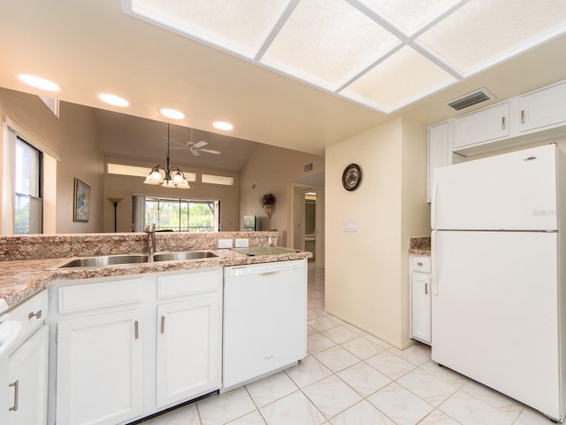 kitchen featuring a sink, visible vents, white appliances, and white cabinets