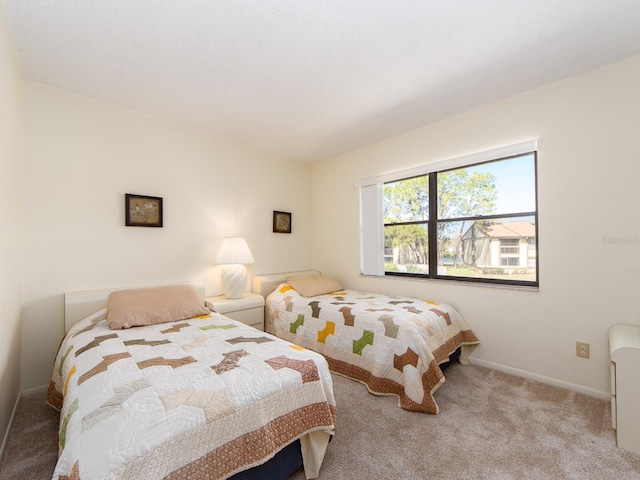 bedroom with carpet and baseboards