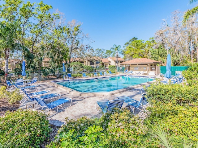 community pool featuring a patio area and fence