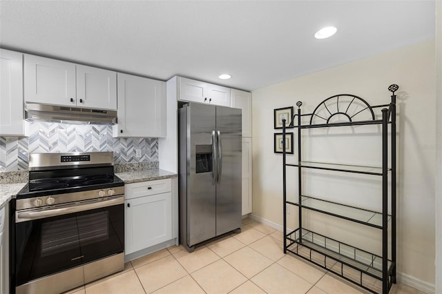 kitchen featuring white cabinets, stainless steel appliances, under cabinet range hood, and backsplash
