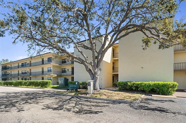 view of property featuring uncovered parking