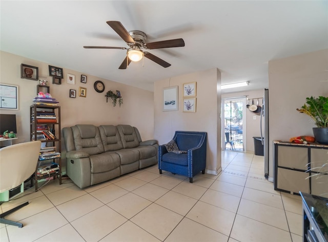 living area with a ceiling fan and light tile patterned flooring