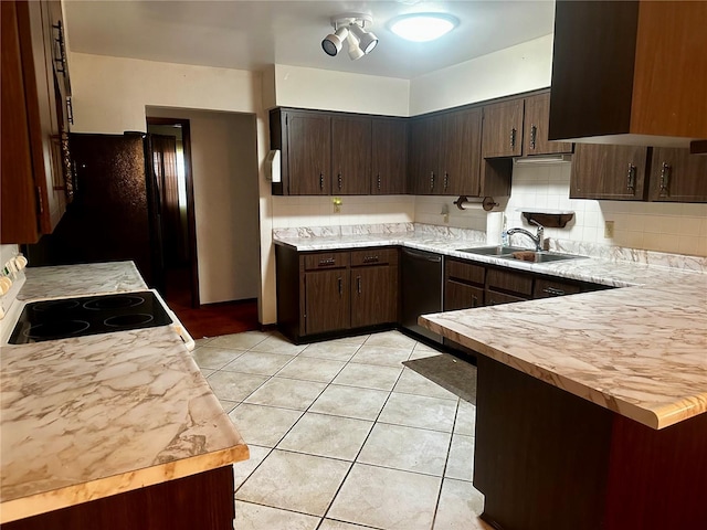 kitchen with electric stove, light tile patterned floors, backsplash, a sink, and dark brown cabinets