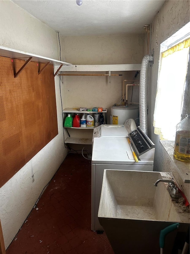 clothes washing area with independent washer and dryer, laundry area, electric water heater, and a sink