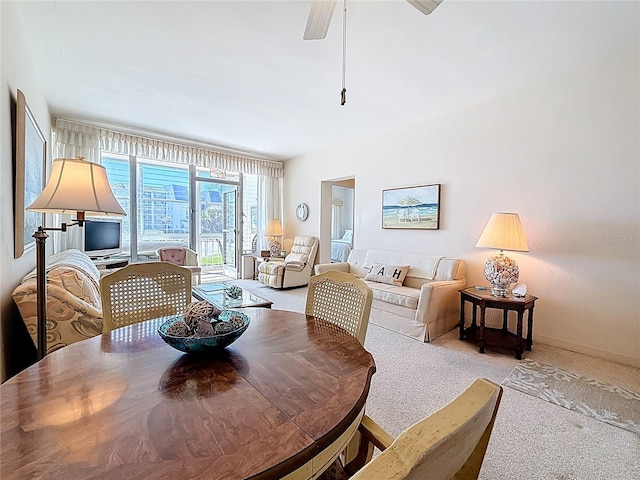 dining room featuring a ceiling fan and carpet