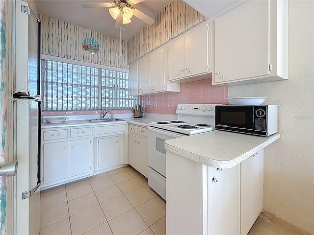 kitchen with white appliances, white cabinets, light countertops, and a sink