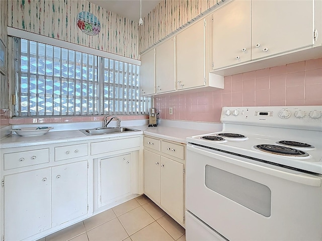 kitchen with a sink, a healthy amount of sunlight, light countertops, and white range with electric stovetop