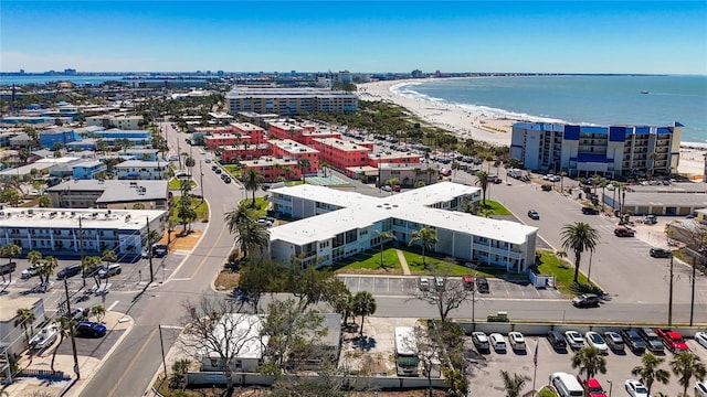 drone / aerial view featuring a water view, a city view, and a view of the beach