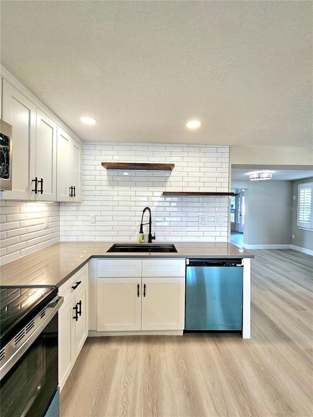 13633 Britton Dr, Hudson, FL 34667 - kitchen with light wood finished floors, dishwasher, a sink, and white cabinets