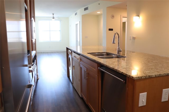 kitchen with dark wood-style floors, visible vents, appliances with stainless steel finishes, a sink, and light stone countertops