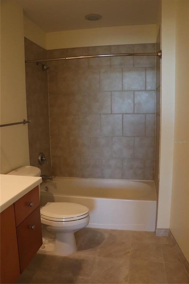 bathroom with toilet, shower / tub combination, tile patterned flooring, and vanity