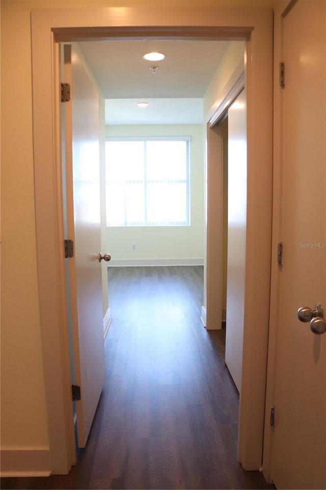 corridor with baseboards, dark wood finished floors, and recessed lighting