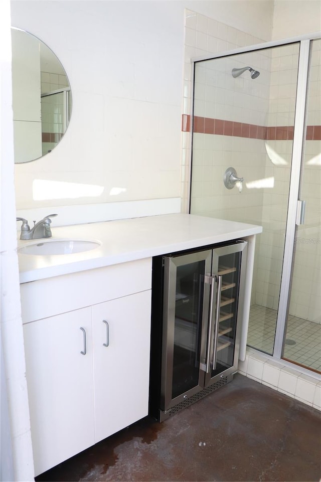 bathroom with a stall shower, wine cooler, concrete floors, and vanity