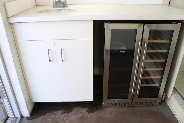 closet featuring wine cooler and a sink