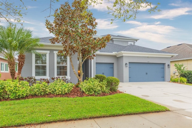 view of front of house featuring a shingled roof, a garage, driveway, and stucco siding