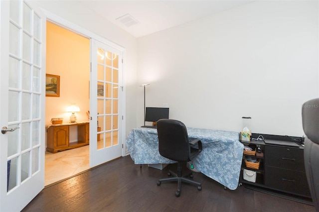 home office with wood finished floors, french doors, and visible vents