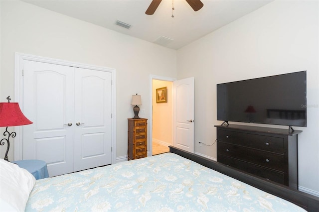 bedroom with a closet, visible vents, ceiling fan, and baseboards