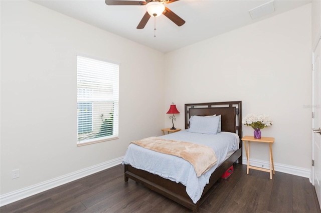 bedroom featuring a ceiling fan, wood finished floors, and baseboards