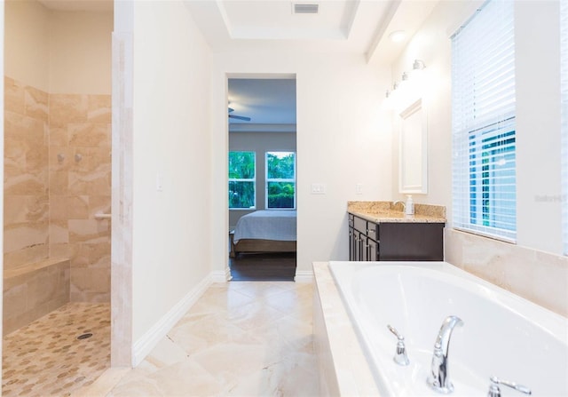 ensuite bathroom featuring visible vents, a garden tub, connected bathroom, baseboards, and vanity