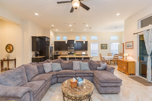 living room with recessed lighting and a ceiling fan