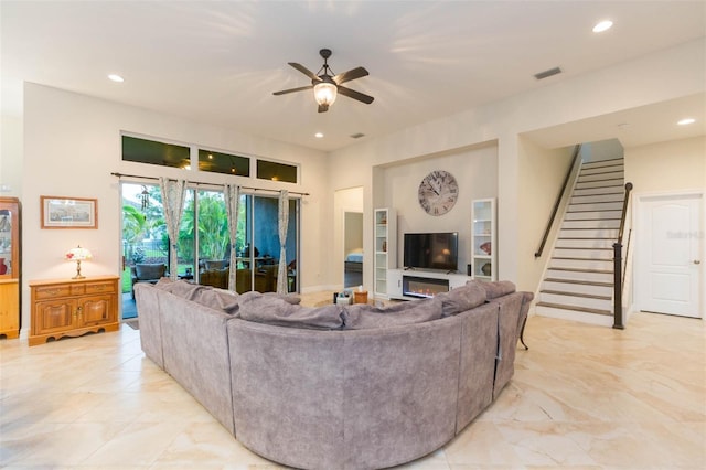 living area featuring stairway, visible vents, recessed lighting, ceiling fan, and marble finish floor