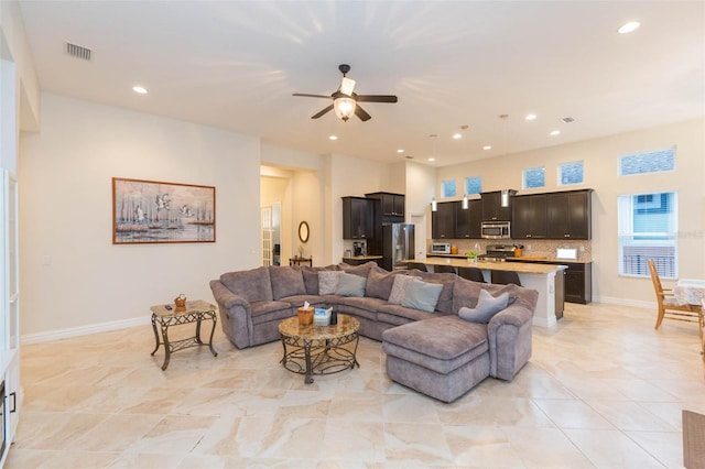 living room featuring recessed lighting, visible vents, baseboards, and ceiling fan