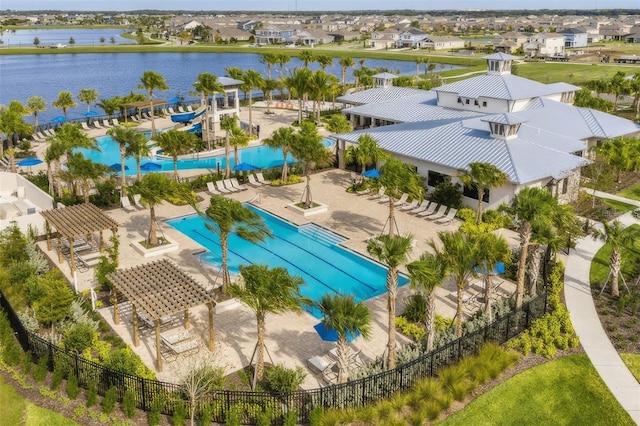 drone / aerial view featuring a residential view and a water view